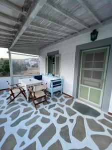 a patio with a table and a couch on a patio at Patmos Villas in Grikos