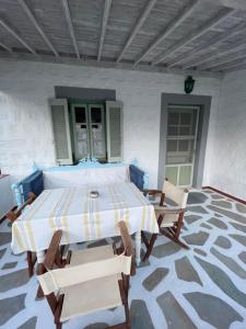a patio with a table and chairs in a room at Patmos Villas in Grikos