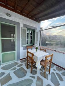 a table and chairs on a balcony with a view at Patmos Villas in Grikos