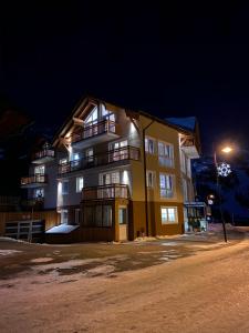 a large yellow building with a light on top at Appartement Haus Faßwald in Obertauern