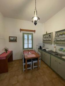 a kitchen with a table and a tableasteryasteryasteryasteryasteryasteryasteryastery at Patmos Villas in Grikos