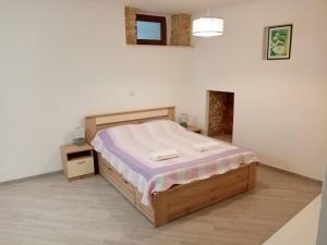 a bedroom with a bed in a white room at Studio apartment Iva in Bale