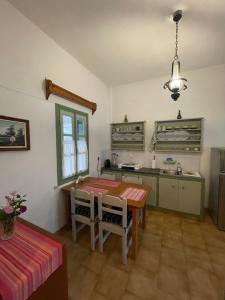a kitchen with a table and a dining room at Patmos Villas in Grikos