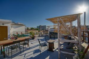 a patio with tables and chairs on a roof at Mascot Boutique Hotel in Rhodes Town