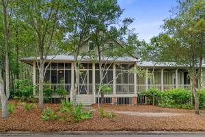 a home with trees in front of it at 13 Lake District Lane in Santa Rosa Beach