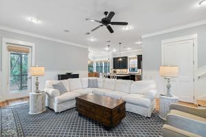 a living room with a white couch and a table at 13 Lake District Lane in Santa Rosa Beach