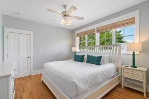 a white bedroom with a bed and a window at 13 Lake District Lane in Santa Rosa Beach +43 photos