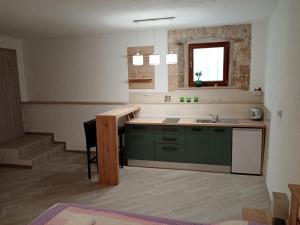 a kitchen with green cabinets and a sink at Apartment Elena in Bale +78 photos