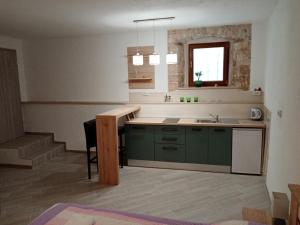 a kitchen with green cabinets and a sink at Apartment Elena in Bale