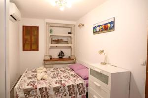 a small bedroom with a bed and a desk at Sailboat house in Korčula