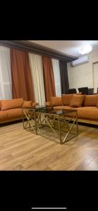 a living room with a couch and a coffee table at Dona Palace Apartments in Tbilisi City