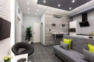 a living room with a couch and a kitchen at Premium Apartment by Hi5 - Central 1 bedroom (217) in Budapest