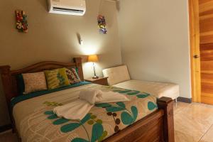 a bedroom with a bed with a robe on it at Hotel Margarita and Tour Operator Drake Bay in Drake