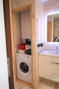 a laundry room with a washing machine and a sink at ANTONIA2 in Brides-les-Bains +18 photos