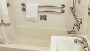 a bathroom with a white tub and a sink at Pacific Heights Inn in San Francisco