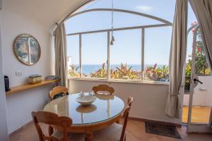 a dining room with a table and a large window at il Pettirosso in Positano in Positano