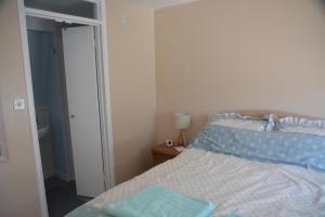 a bedroom with a bed with a blue pillow on it at The Garrett in Melcombe Regis