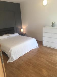 a bedroom with a white bed and a white dresser at Amelia Apartment in Vodice