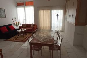 a living room with a glass table and chairs at Semith Home 1 in Kalabaka