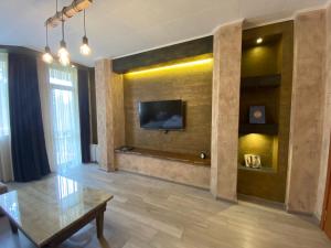 a living room with a tv on a wall at Deluxe 217 in Borovets