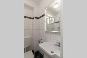 a bathroom with a sink and a toilet and a mirror at Kuća za odmor Mihaela in Sutivan +5 photos