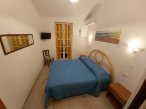 a bedroom with a blue bed in a room at Villa l'Amante in Fondi