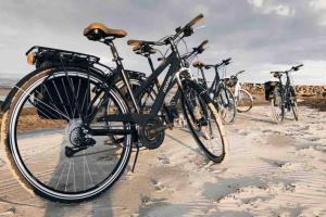 a group of bikes parked on the beach at Piparmētras in Mērsrags