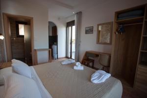 a hotel room with a bed with towels on it at Panorama Studios in Kefalos