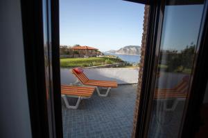 two chairs sitting on a balcony with a view of the water at Panorama Studios in Kefalos