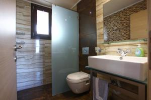 a bathroom with a sink and a toilet at Panorama Studios in Kefalos