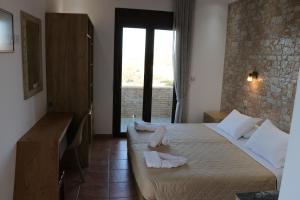 a hotel room with a bed with towels on it at Panorama Studios in Kefalos