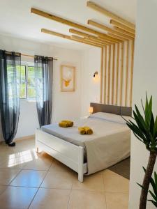 a bedroom with a bed with two yellow pillows on it at Travellers Guesthouse in Lagos +77 photos