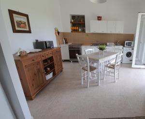 a kitchen with a table and chairs in a room at Villa leone 2 in Pisticci