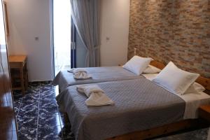 a hotel room with a bed with towels on it at Panorama Studios in Kefalos