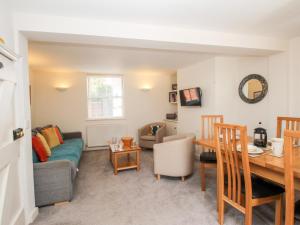 a living room with a couch and a table at Firkin Cottage in Weymouth
