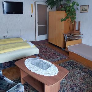 a room with two beds and a table with glasses on it at OPEN Vendégház in Sopron