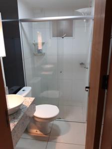 a bathroom with a shower with a toilet and a sink at Apto JK Universitário - Express in Santa Cruz do Sul +4 photos