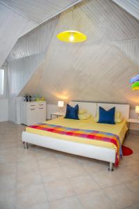 a bedroom with a large bed with a yellow ceiling at Kanavelic place - Old town Korcula in Korčula