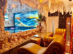 a living room with a fish tank in a room with a couch at Bali Colosseum Hotel in Belgrade