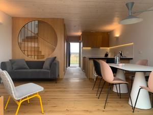 a living room with a couch and a table and chairs at Aurora apartments in Palanga