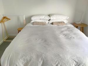 a large white bed with two pillows on it at Lake Tekapo Double Room shared facilities in Lake Tekapo