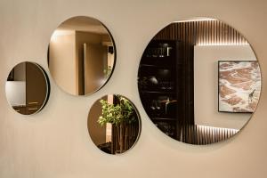 three mirrors on a wall in a bathroom at The Acacia, Luxury with Private Balcony + Parking in Leicester