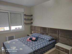 a bedroom with a bed with a tray on it at Lindo apartamento ao lado do Park Shopping Canoas in Canoas