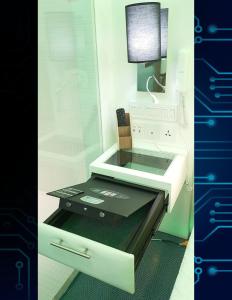 a kitchen with a sink with a glass counter top at iOtel Luxury Kiosk Hotel in Angeles