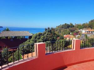 a balcony of a house with a view of the ocean at Casa Monarca in Chacala +5 photos