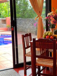 a dining room table with fruits and vegetables on it at Casa Monarca in Chacala