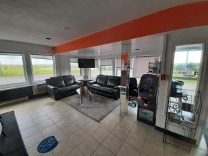a living room with a couch and a gas station at Howard Johnson by Wyndham Woodstock NB in Woodstock