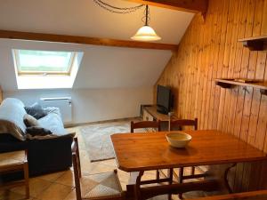 a living room with a table and a couch at Appartement Montgenèvre, 2 pièces, 6 personnes - FR-1-445-164 in Montgenèvre