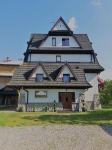 a house with a gambrel roof on top at Czekoladowa Willa in Białka Tatrzanska