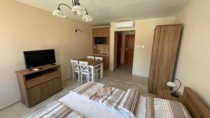 a bedroom with a bed and a television in a room at Marcell Apartman in Gyula